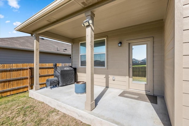 view of patio / terrace featuring grilling area and fence