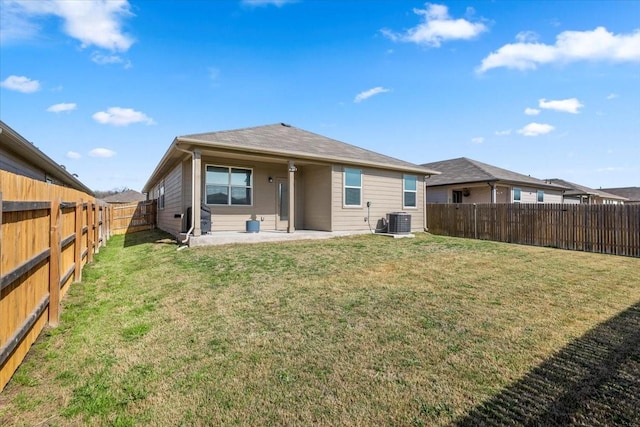 rear view of property with a yard, a patio, central AC unit, and a fenced backyard