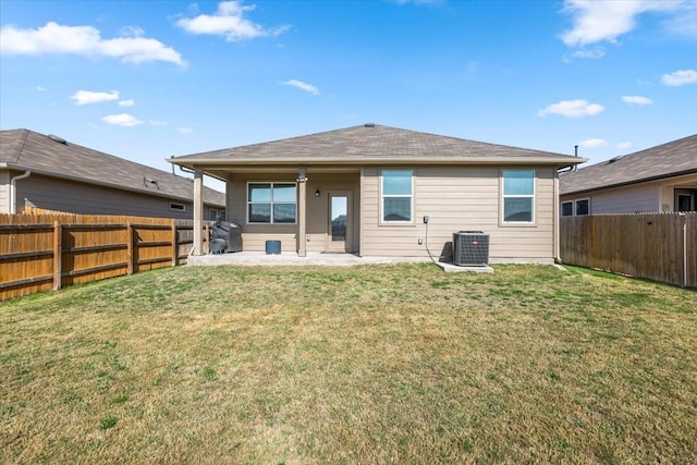 rear view of house featuring a yard, a fenced backyard, and cooling unit