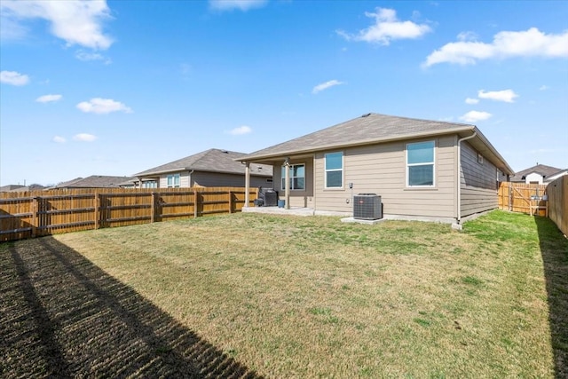 back of house featuring a yard, central AC unit, a fenced backyard, and a patio area