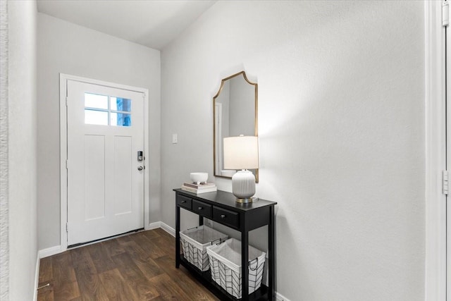 entryway featuring dark wood finished floors and baseboards