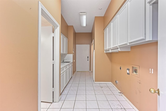 laundry area with hookup for an electric dryer, cabinet space, a sink, washer hookup, and hookup for a gas dryer