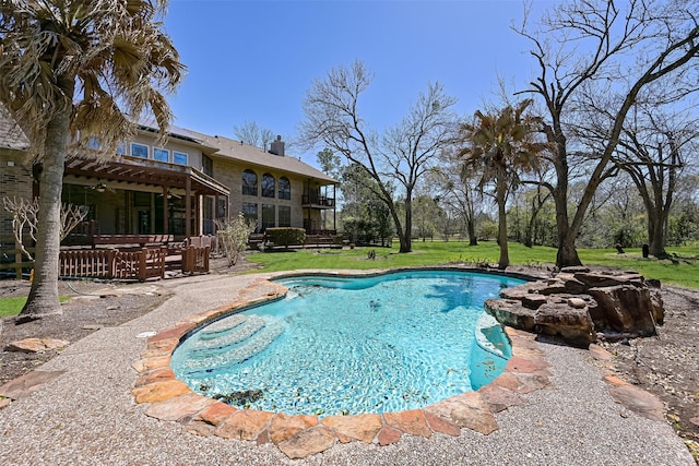 pool with a patio, a yard, and ceiling fan