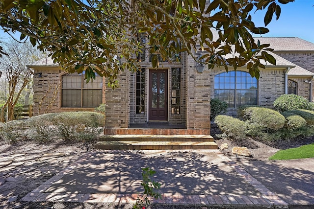 property entrance featuring brick siding