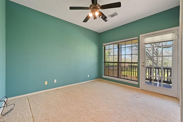 carpeted spare room with a ceiling fan, baseboards, visible vents, and a textured ceiling