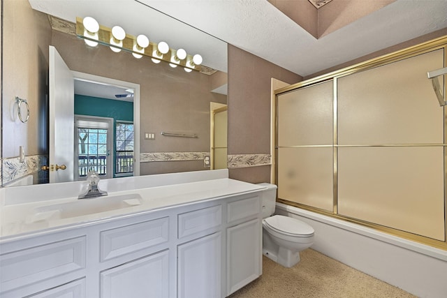 bathroom featuring vanity, toilet, and bath / shower combo with glass door