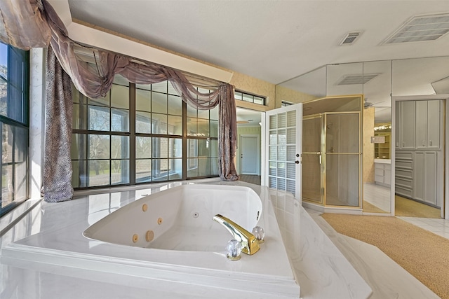 full bath featuring tile patterned flooring, a shower stall, visible vents, and a whirlpool tub