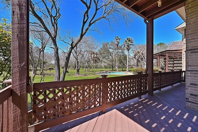 wooden deck featuring a yard