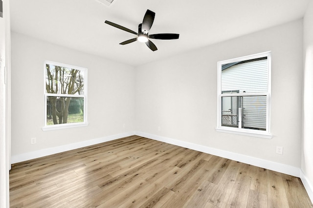 spare room with wood finished floors, baseboards, and ceiling fan