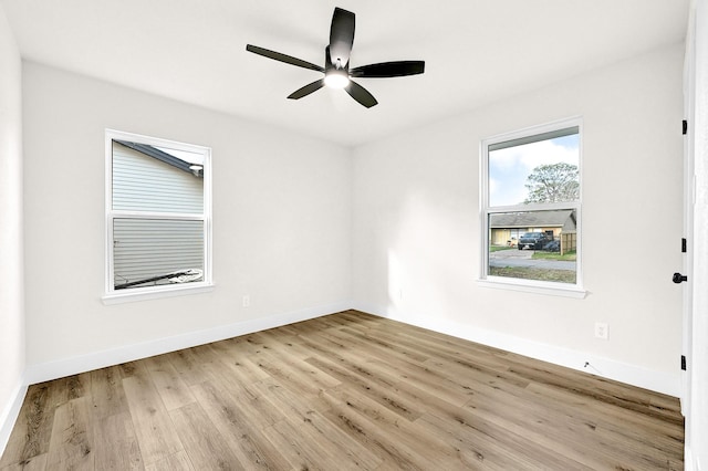 unfurnished room with light wood-style floors, baseboards, and ceiling fan