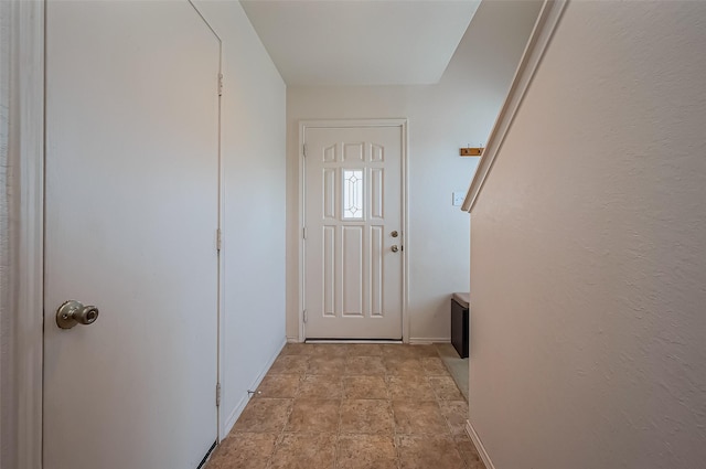 doorway to outside featuring baseboards