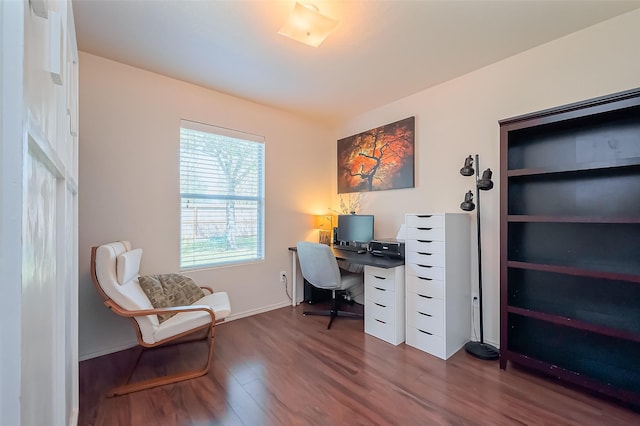 office area featuring dark wood-type flooring and baseboards