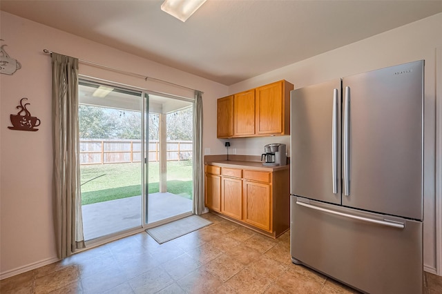 kitchen with light countertops and freestanding refrigerator