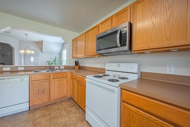 kitchen featuring a sink, decorative light fixtures, white appliances, lofted ceiling, and a chandelier