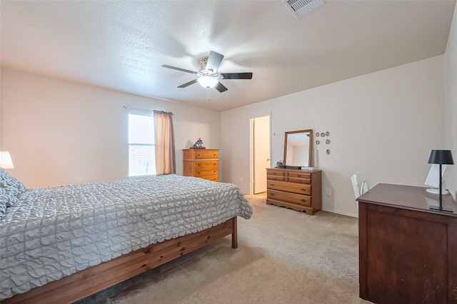 carpeted bedroom featuring visible vents and ceiling fan