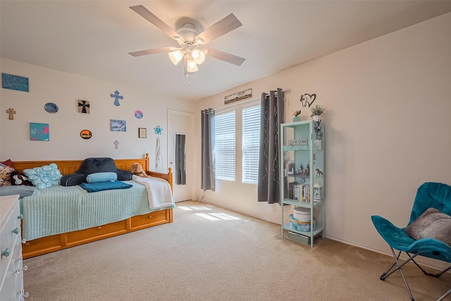 bedroom featuring a ceiling fan and carpet