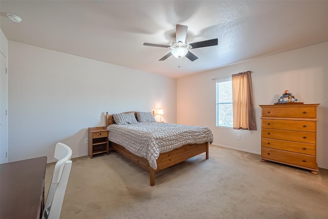 bedroom with baseboards, light colored carpet, and ceiling fan