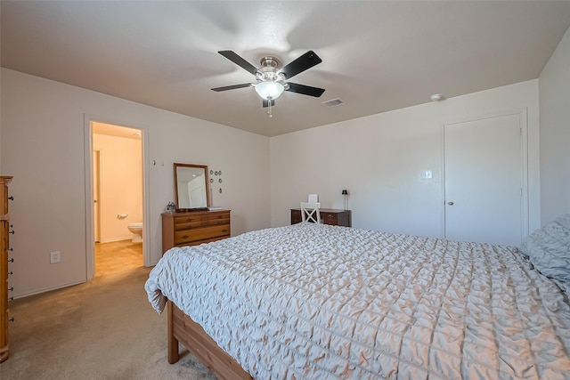 bedroom with visible vents, carpet flooring, ensuite bathroom, and ceiling fan