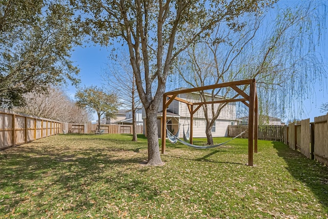 view of yard with a playground and a fenced backyard