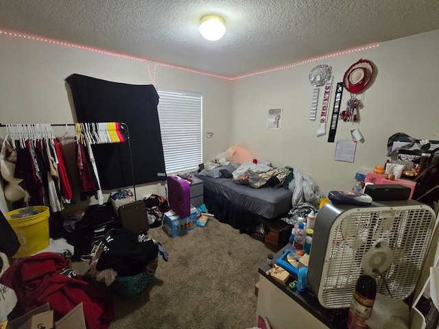 bedroom featuring a textured ceiling and carpet floors