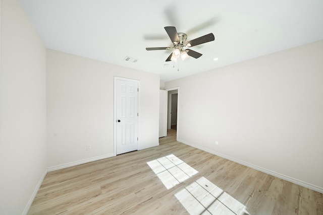 unfurnished bedroom with light wood finished floors, visible vents, a ceiling fan, and baseboards