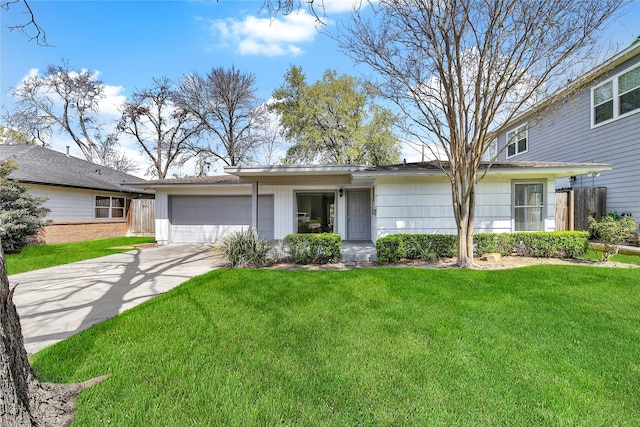 view of front of property with an attached garage, driveway, and a front yard