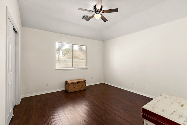 unfurnished bedroom with visible vents, baseboards, dark wood finished floors, vaulted ceiling, and a closet