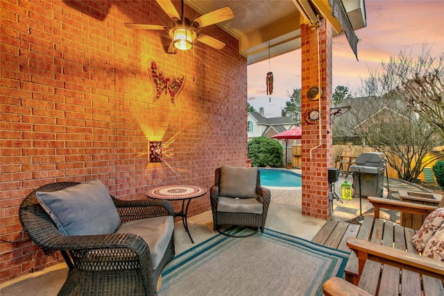 patio terrace at dusk featuring an outdoor pool, a grill, ceiling fan, and fence