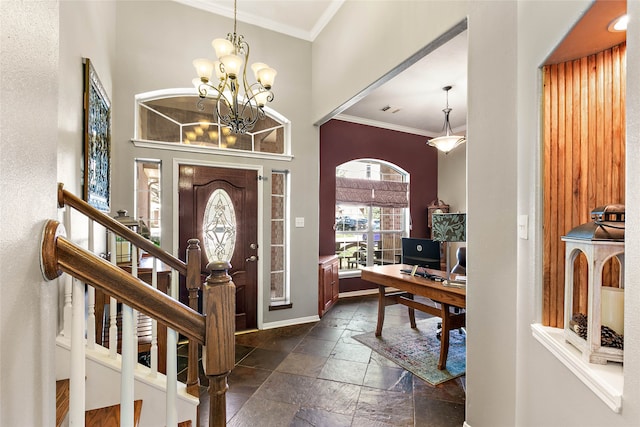 entrance foyer featuring visible vents, a notable chandelier, stone tile floors, and ornamental molding