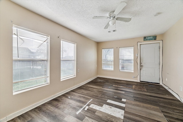 unfurnished room featuring visible vents, baseboards, wood finished floors, a textured ceiling, and a ceiling fan