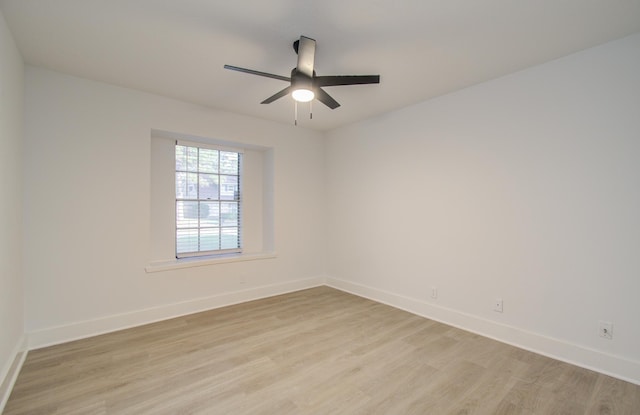 spare room with light wood-style flooring, baseboards, and ceiling fan