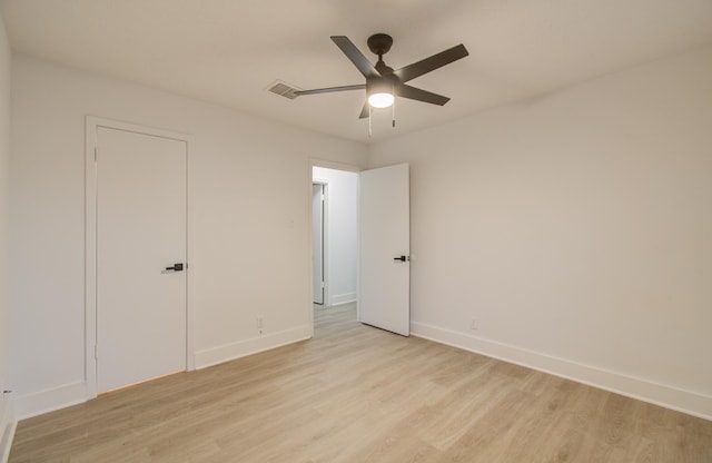 unfurnished bedroom with a ceiling fan, visible vents, baseboards, and light wood-type flooring