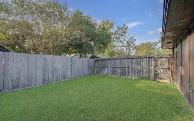 view of yard with a fenced backyard