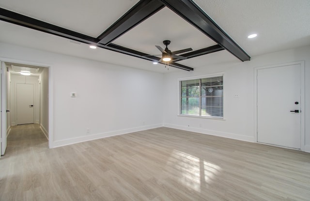 unfurnished room with beam ceiling, attic access, a ceiling fan, and light wood finished floors