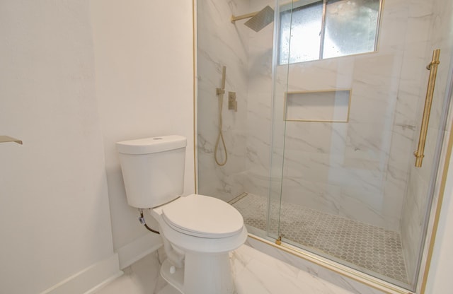 bathroom with a marble finish shower, baseboards, toilet, and marble finish floor