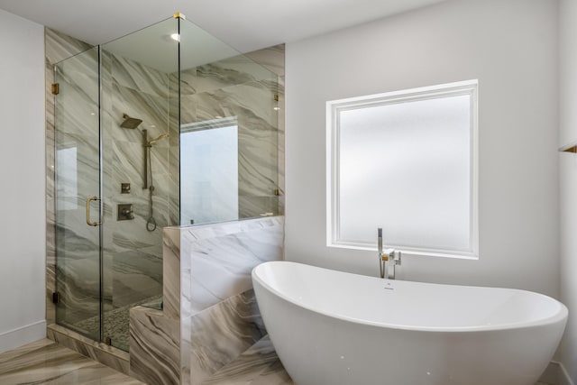 bathroom featuring a marble finish shower, a soaking tub, and marble finish floor