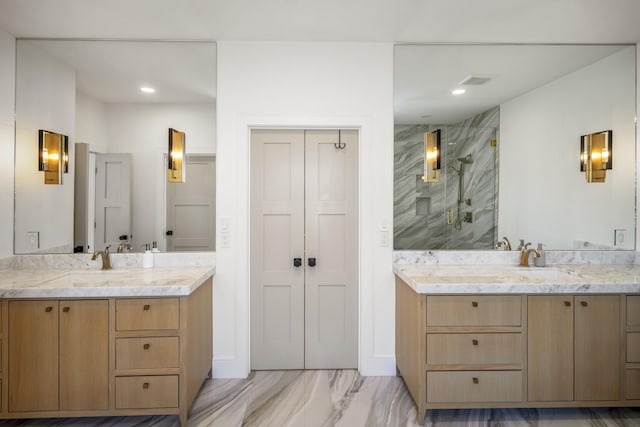 bathroom featuring two vanities, recessed lighting, marble finish floor, and a marble finish shower