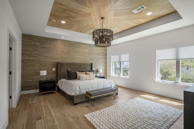 bedroom featuring a tray ceiling, wood ceiling, visible vents, and a chandelier