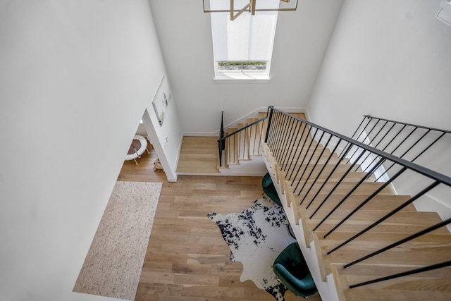 stairway featuring baseboards and wood finished floors