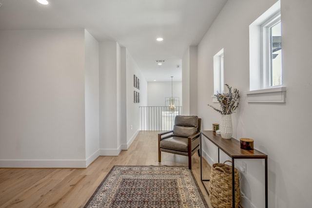 corridor featuring recessed lighting, baseboards, and light wood-style flooring