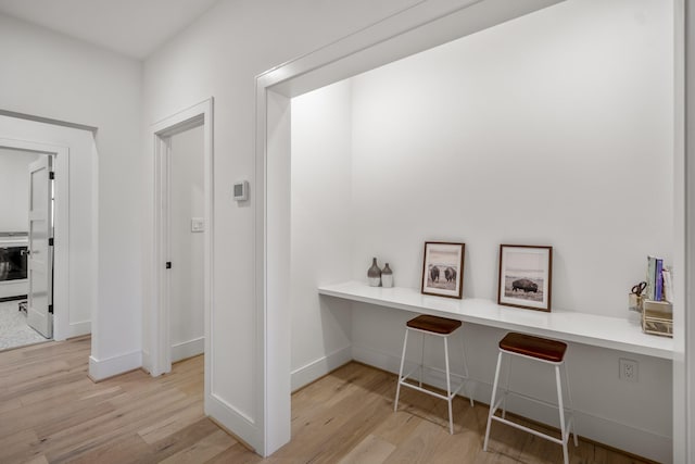 interior space with light wood-type flooring and baseboards