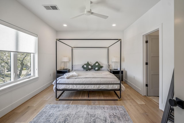 bedroom with light wood-style flooring, recessed lighting, baseboards, and visible vents