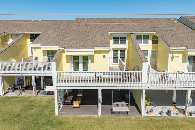 back of property featuring a yard, a patio, roof with shingles, and french doors