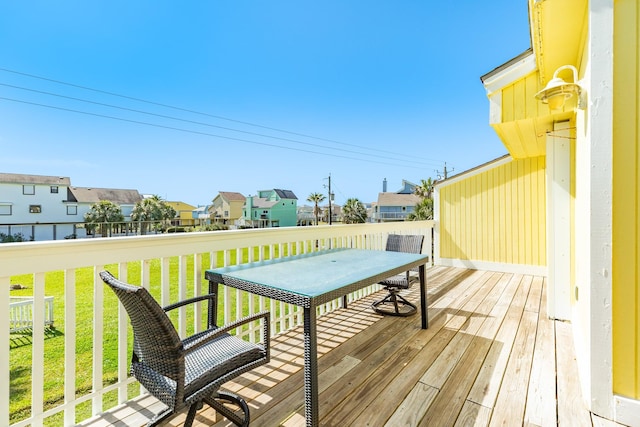 wooden deck with a residential view and a lawn