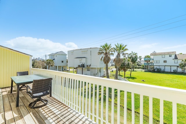 deck with a residential view and a lawn