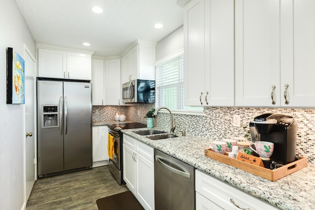 kitchen featuring tasteful backsplash, a sink, white cabinets, stainless steel appliances, and dark wood-style flooring