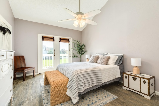 bedroom with dark wood finished floors, access to exterior, baseboards, and lofted ceiling