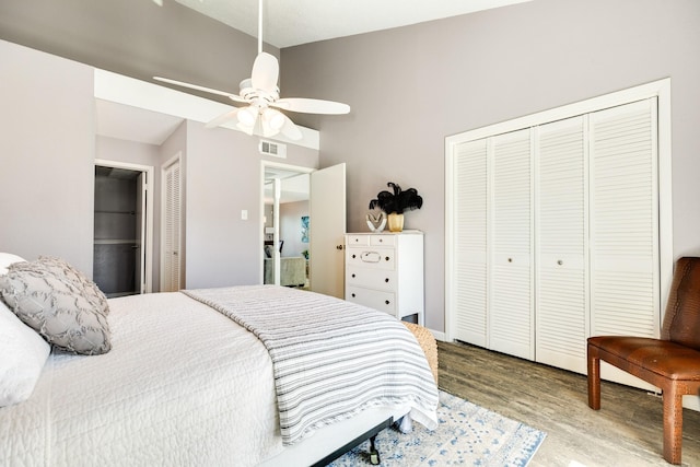 bedroom featuring ceiling fan, visible vents, and wood finished floors