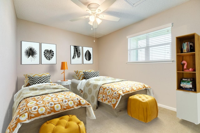 carpeted bedroom with a ceiling fan, baseboards, and a textured ceiling