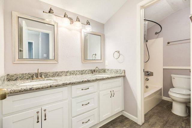 full bath featuring double vanity, toilet, bathtub / shower combination, and a sink